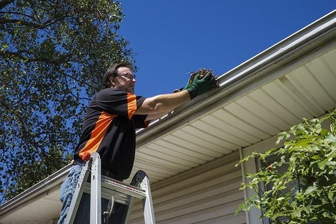 a close-up of a gutter being fixed with tools in Detroit